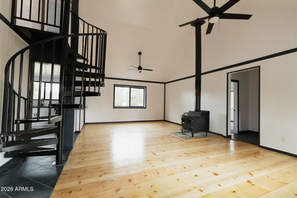 a view of staircase with lots of frames on wall and a large window