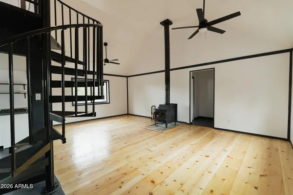 a view of staircase with lots of frames on wall and a window