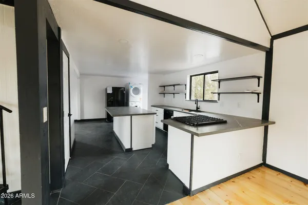 a view of a room with wooden floor and windows