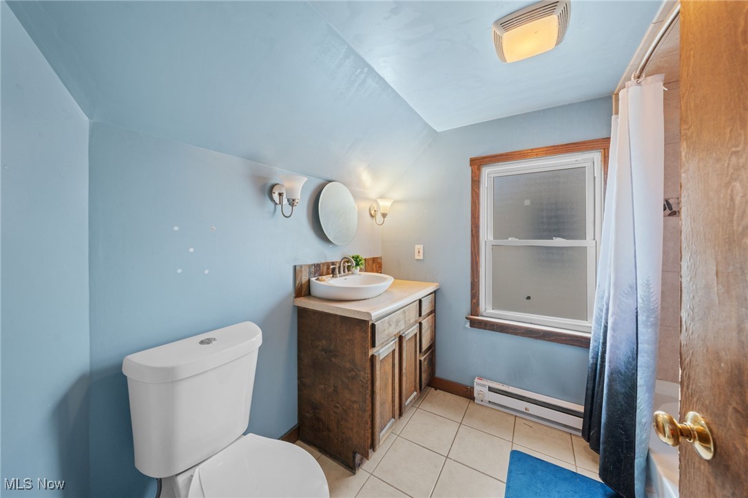 4146 Wyncote Road South Euclid, OH 44121 - Photo 19 of 20 Full bath featuring toilet, vanity, a baseboard heating unit, vaulted ceiling, and tile patterned flooring