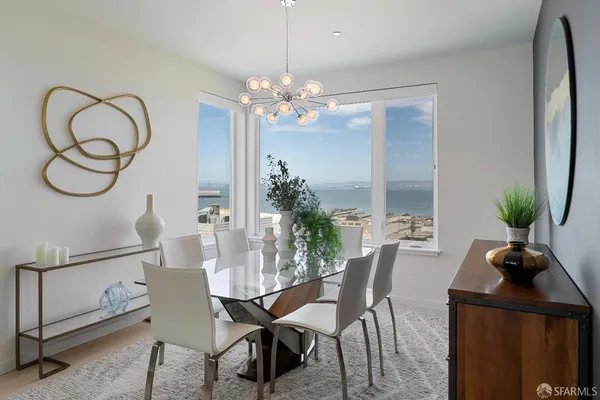 a view of a dining room with furniture and a chandelier