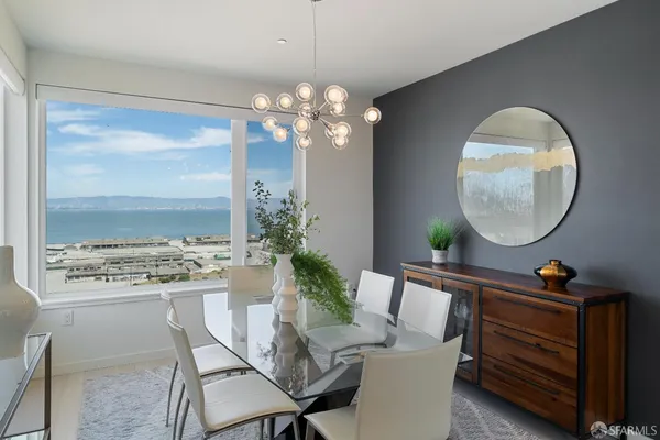 a view of a dining room with furniture and a chandelier