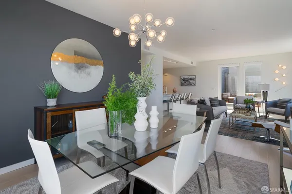 a view of a dining room with furniture and a chandelier