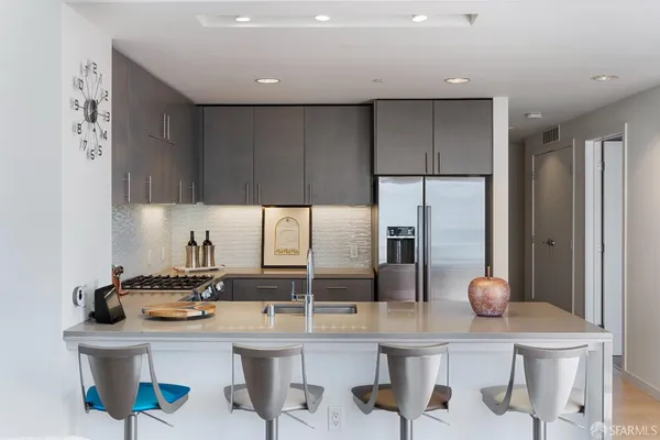 a kitchen with stainless steel appliances a sink counter space and cabinets