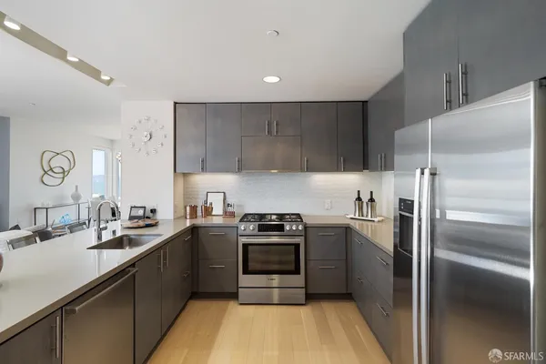 a kitchen with a sink stainless steel appliances and cabinets