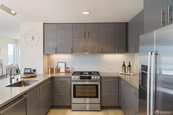 a kitchen with a sink stove and refrigerator