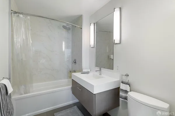 a bathroom with a sink mirror vanity and toilet
