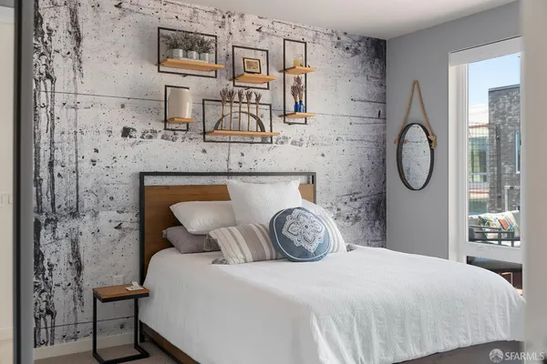 a bedroom with a bed and a chandelier