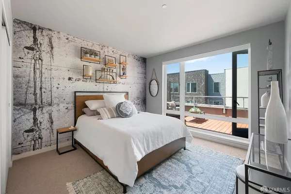 a bedroom with a bed and a large window with outer view