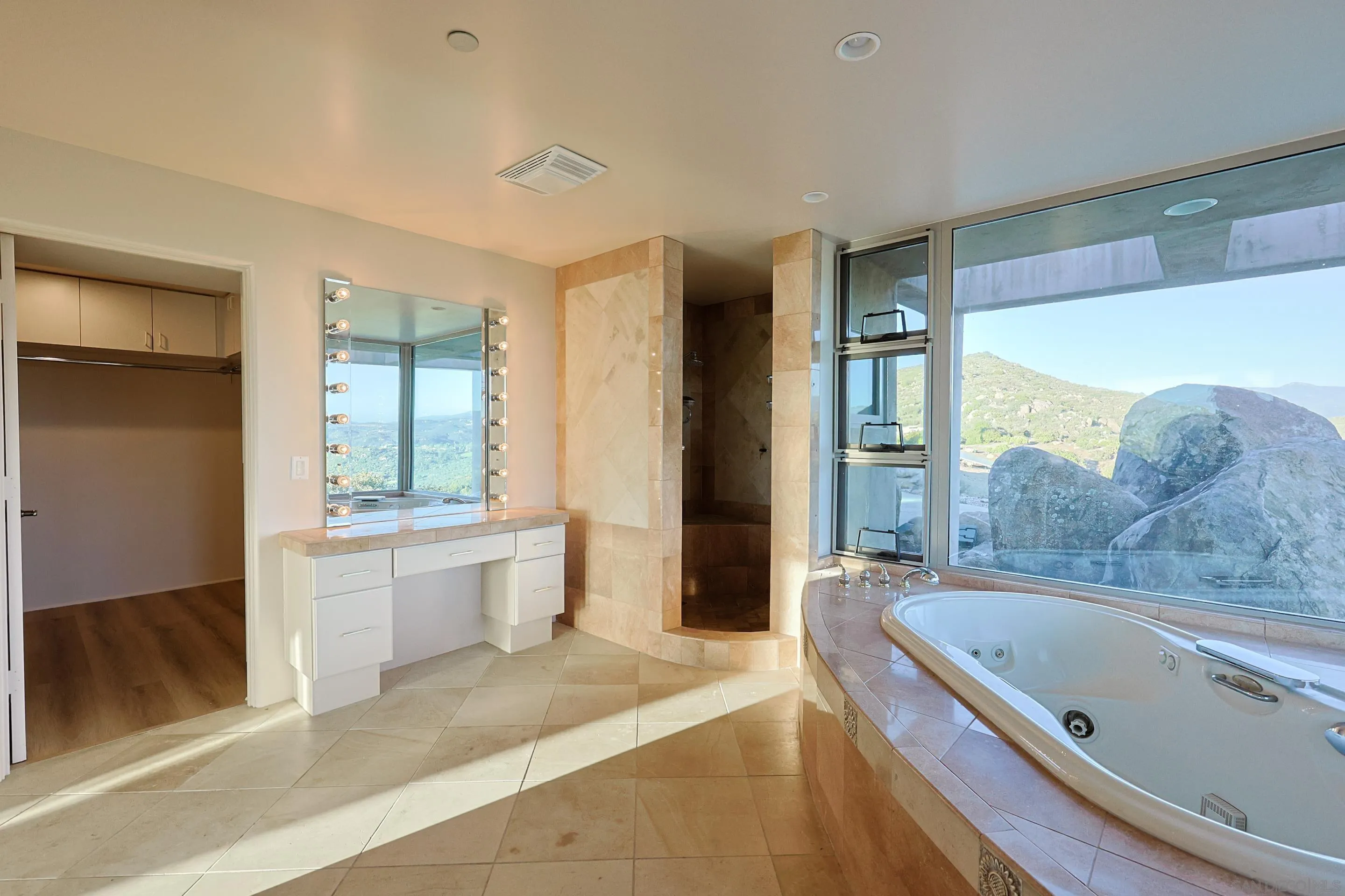 15740 Broad Oaks Road El Cajon, CA 92021 - Photo 20 of 47 a bathroom with a granite countertop tub a sink and a large mirror