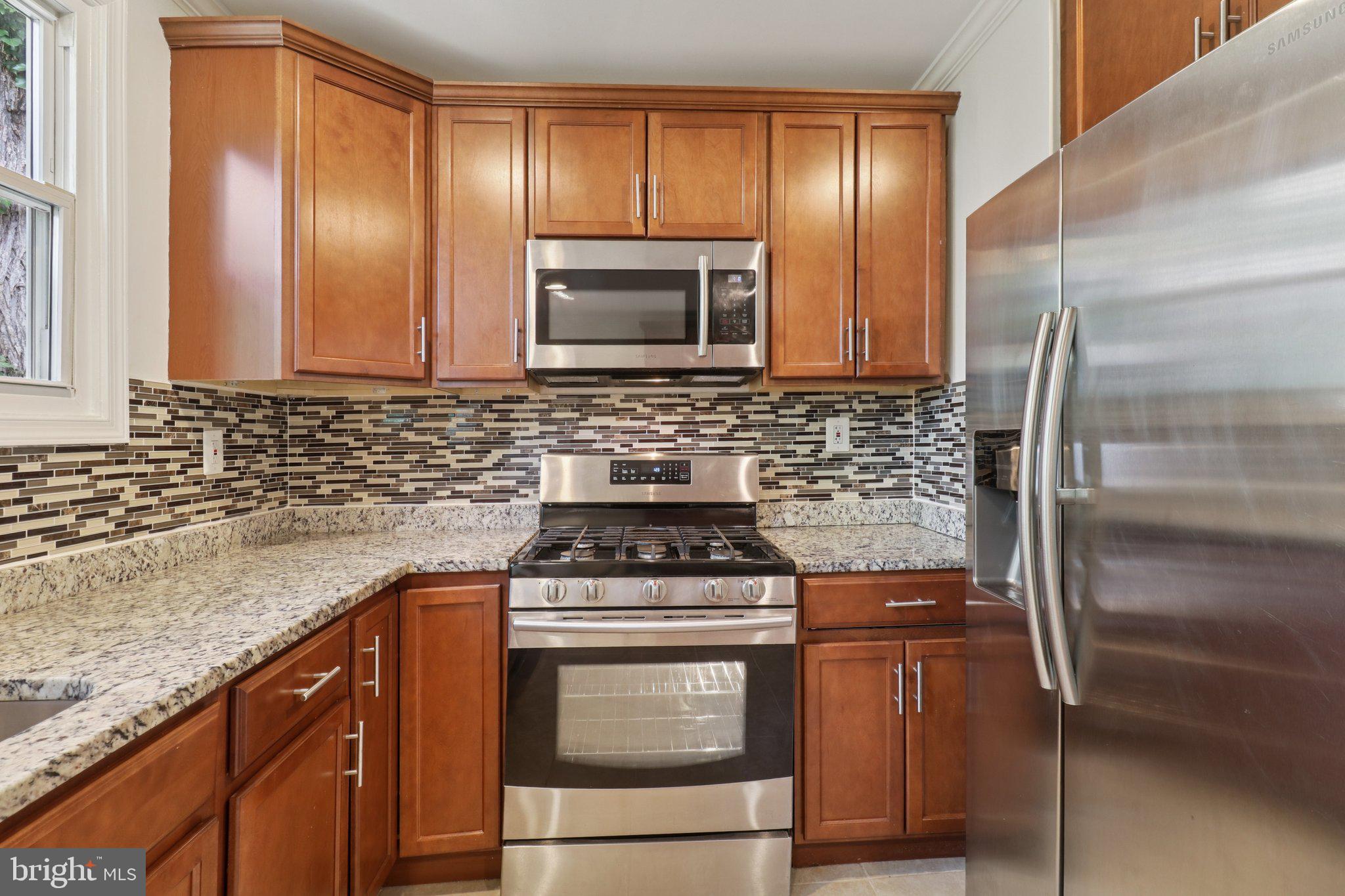 4604 Morgan Road Suitland, MD 20746 - Photo 12 of 38 a kitchen with a stove microwave and refrigerator
