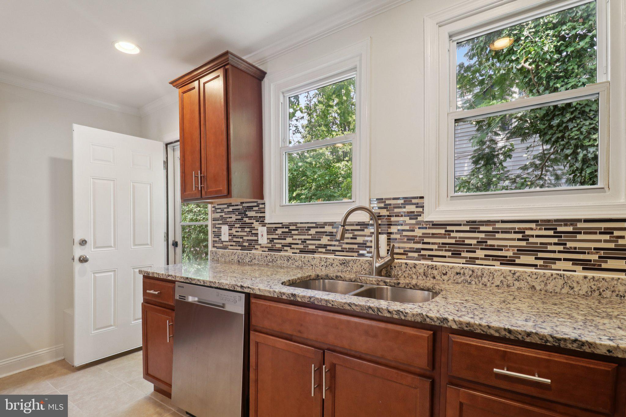 4604 Morgan Road Suitland, MD 20746 - Photo 14 of 38 a kitchen with granite countertop a sink and a window