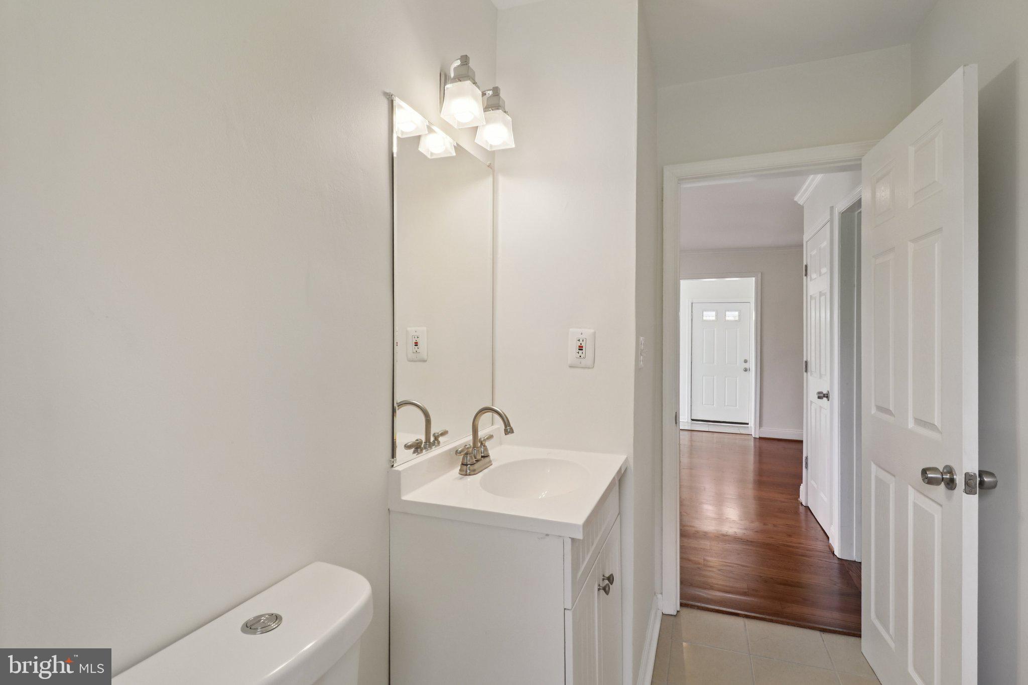 4604 Morgan Road Suitland, MD 20746 - Photo 22 of 38 a bathroom with a sink a light fixture and a mirror