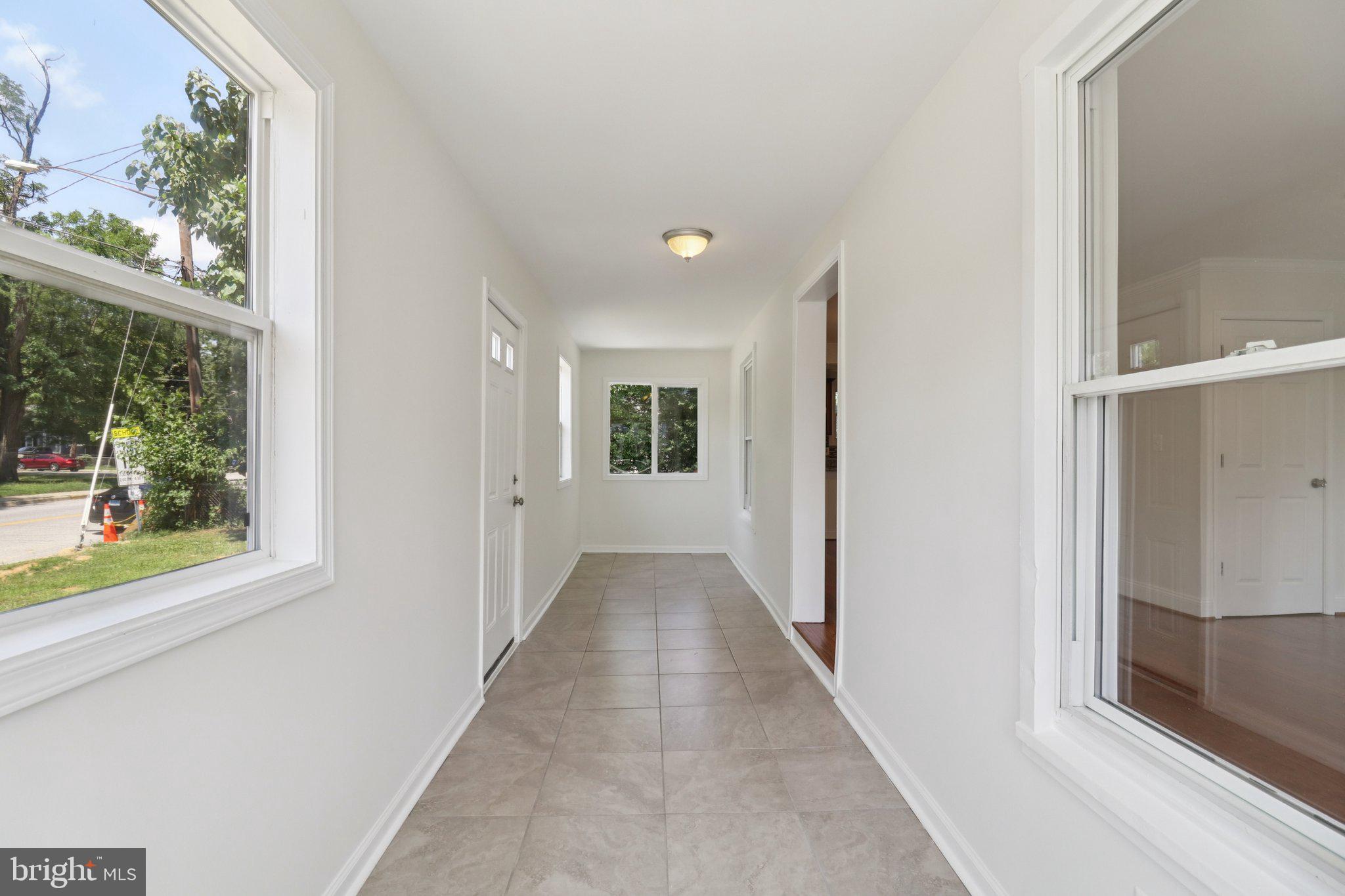 4604 Morgan Road Suitland, MD 20746 - Photo 4 of 38 a view of a hallway with wooden floor and a window