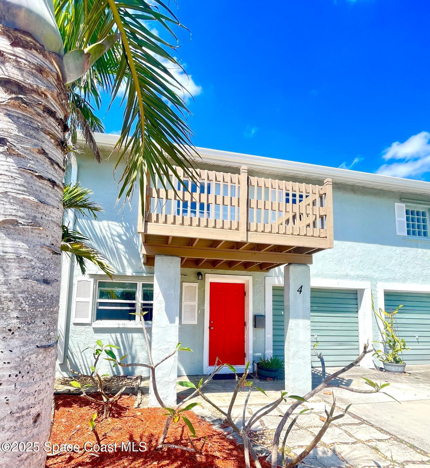 1282 Jimmy Buffett Mem Highway, Unit 4 Satellite Beach, FL 32937 - Photo 1 of 22 a front view of a house with a yard