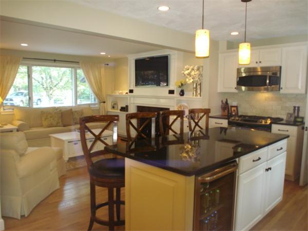 12 Red Barn Road Wayland, MA 01778 - Photo 2 of 16 a kitchen with stainless steel appliances granite countertop sink stove and white cabinets with wooden floor