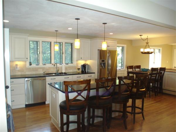 12 Red Barn Road Wayland, MA 01778 - Photo 3 of 16 a kitchen with a dining table chairs cabinets and stainless steel appliances