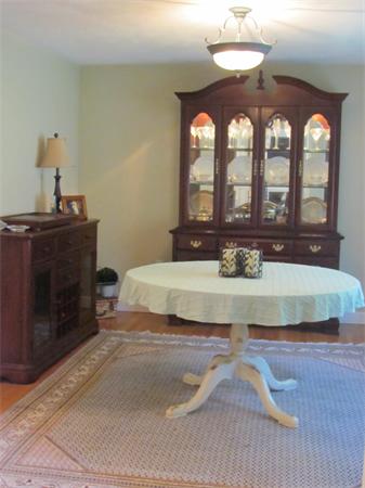 12 Red Barn Road Wayland, MA 01778 - Photo 6 of 16 a bedroom with a bed and a chandelier