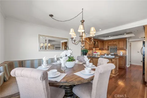 a view of a dining room with furniture wooden floor and chandelier