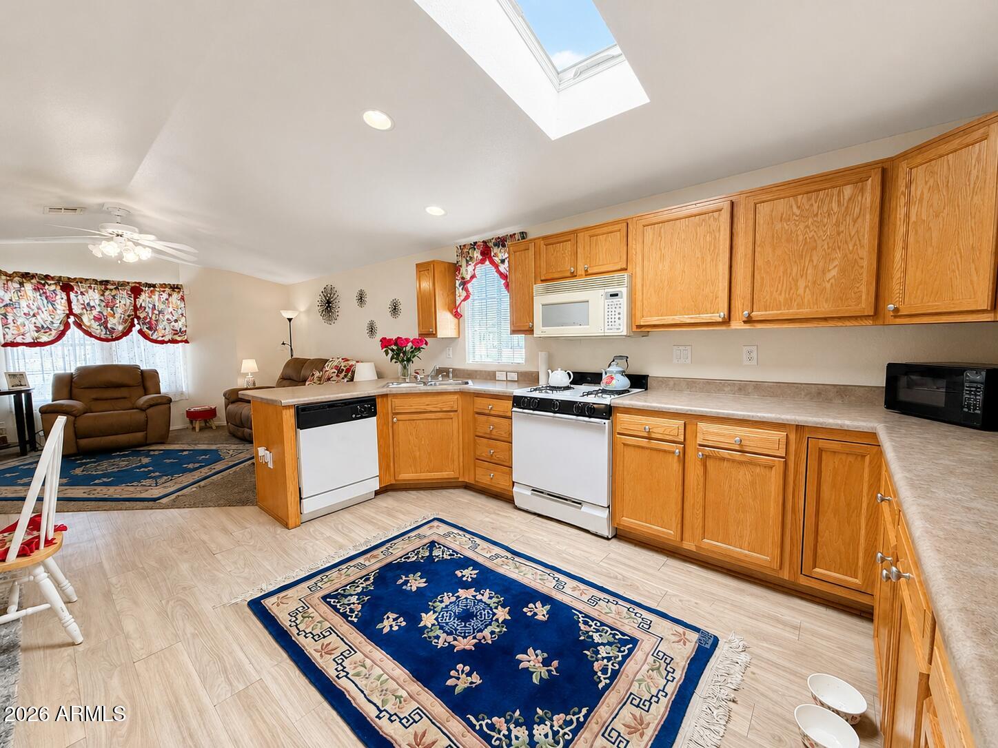 201 South Greenfield Road, Unit 11 Mesa, AZ 85206 - Photo 9 of 22 a kitchen with stainless steel appliances granite countertop a stove a sink dishwasher and cabinets with wooden floor