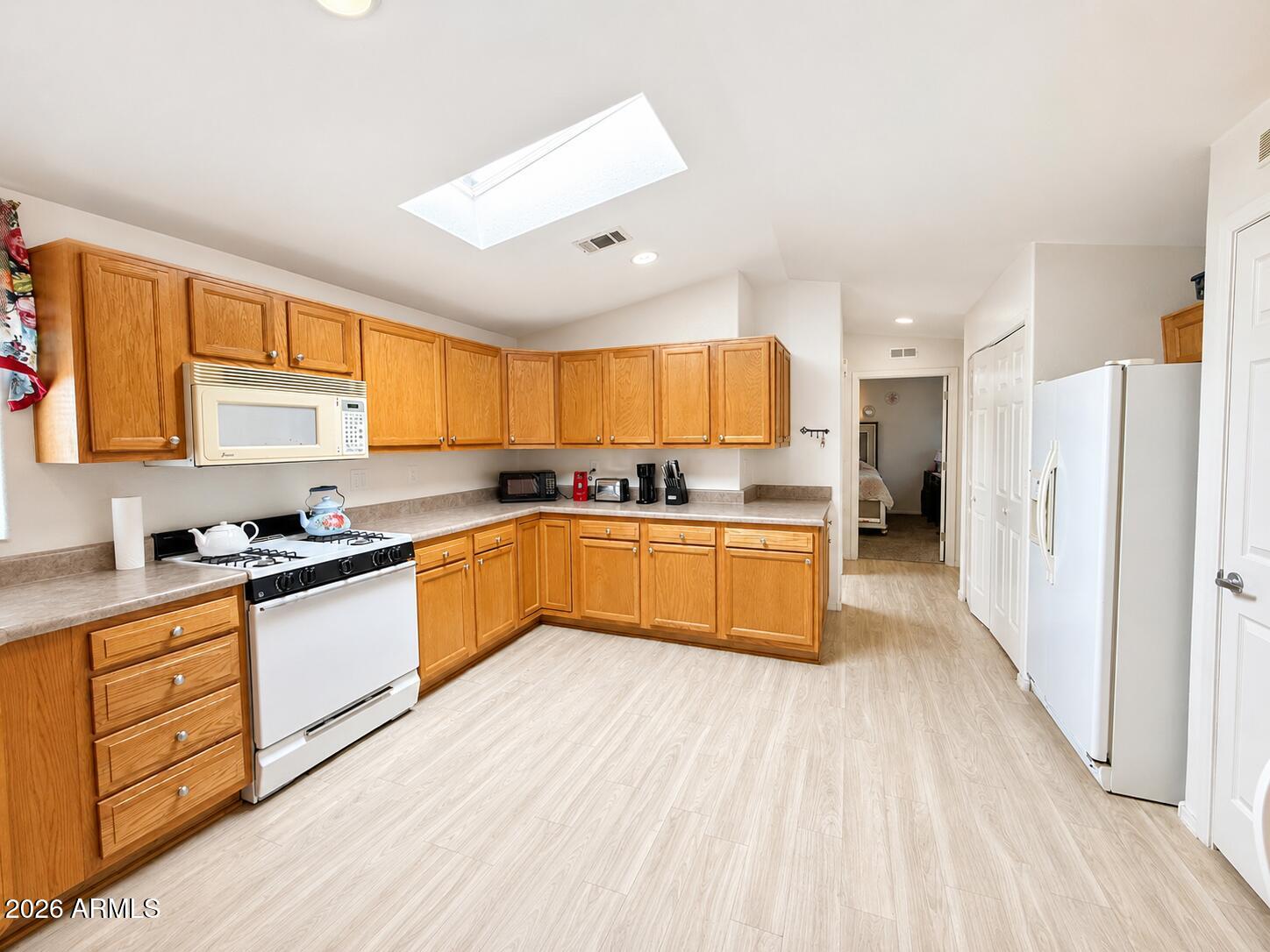 201 South Greenfield Road, Unit 11 Mesa, AZ 85206 - Photo 10 of 22 a kitchen with stainless steel appliances a refrigerator sink and cabinets