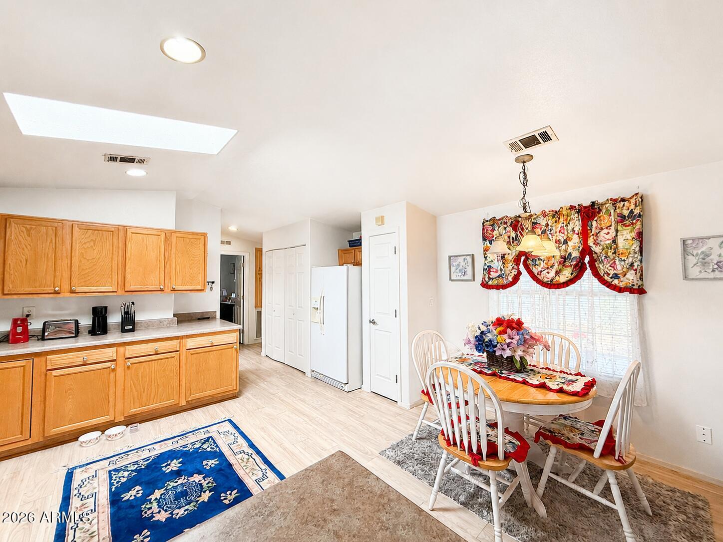 201 South Greenfield Road, Unit 11 Mesa, AZ 85206 - Photo 12 of 22 a kitchen that has a table and chairs in it