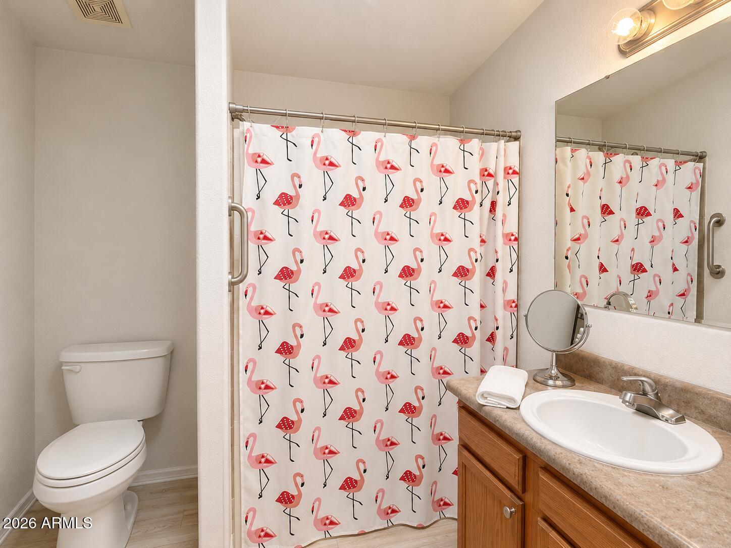 201 South Greenfield Road, Unit 11 Mesa, AZ 85206 - Photo 15 of 22 a bathroom with a granite countertop sink a toilet and a shower curtain