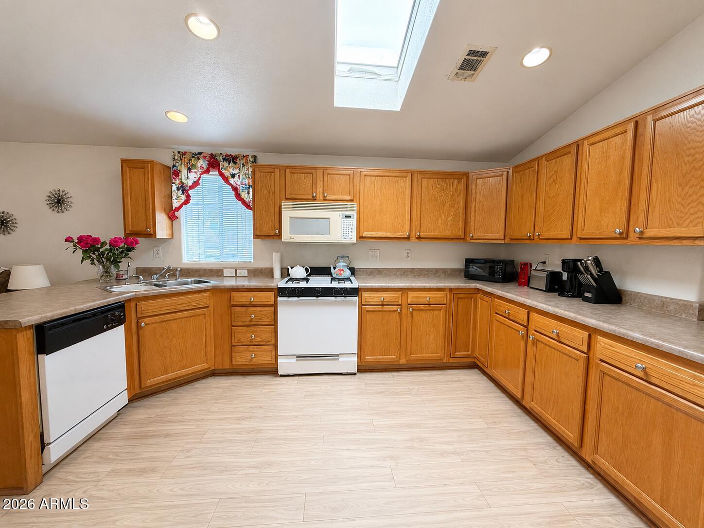 201 South Greenfield Road, Unit 11 Mesa, AZ 85206 - Photo 2 of 22 a kitchen with stainless steel appliances granite countertop a stove a sink and a refrigerator