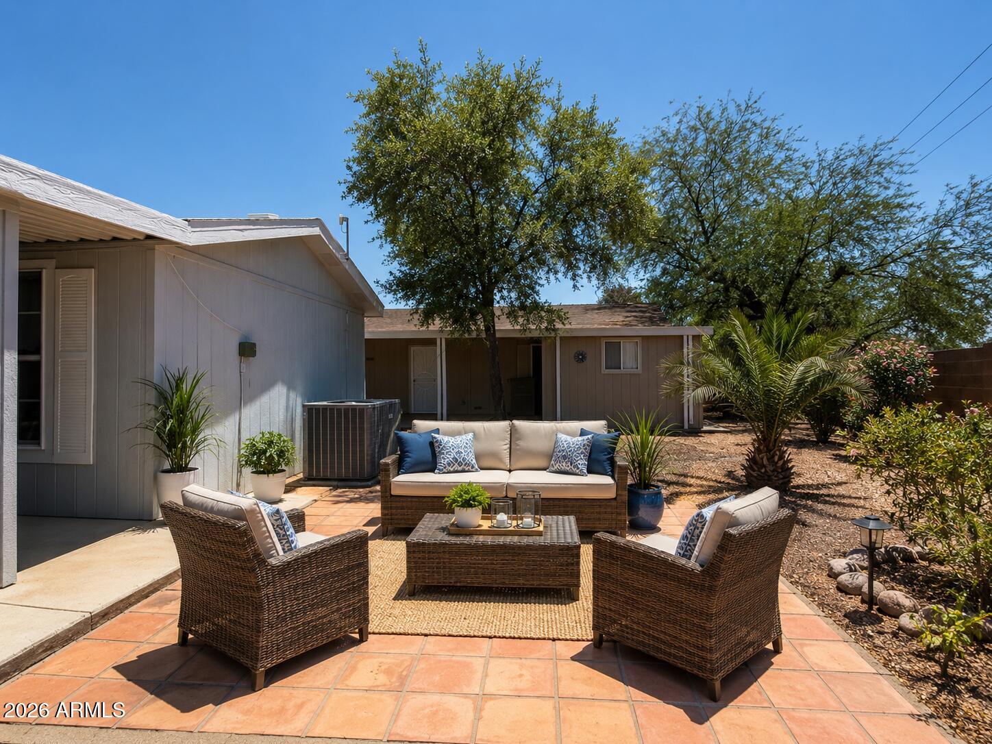 201 South Greenfield Road, Unit 11 Mesa, AZ 85206 - Photo 4 of 22 a view of a patio with couches and potted plants with sky view