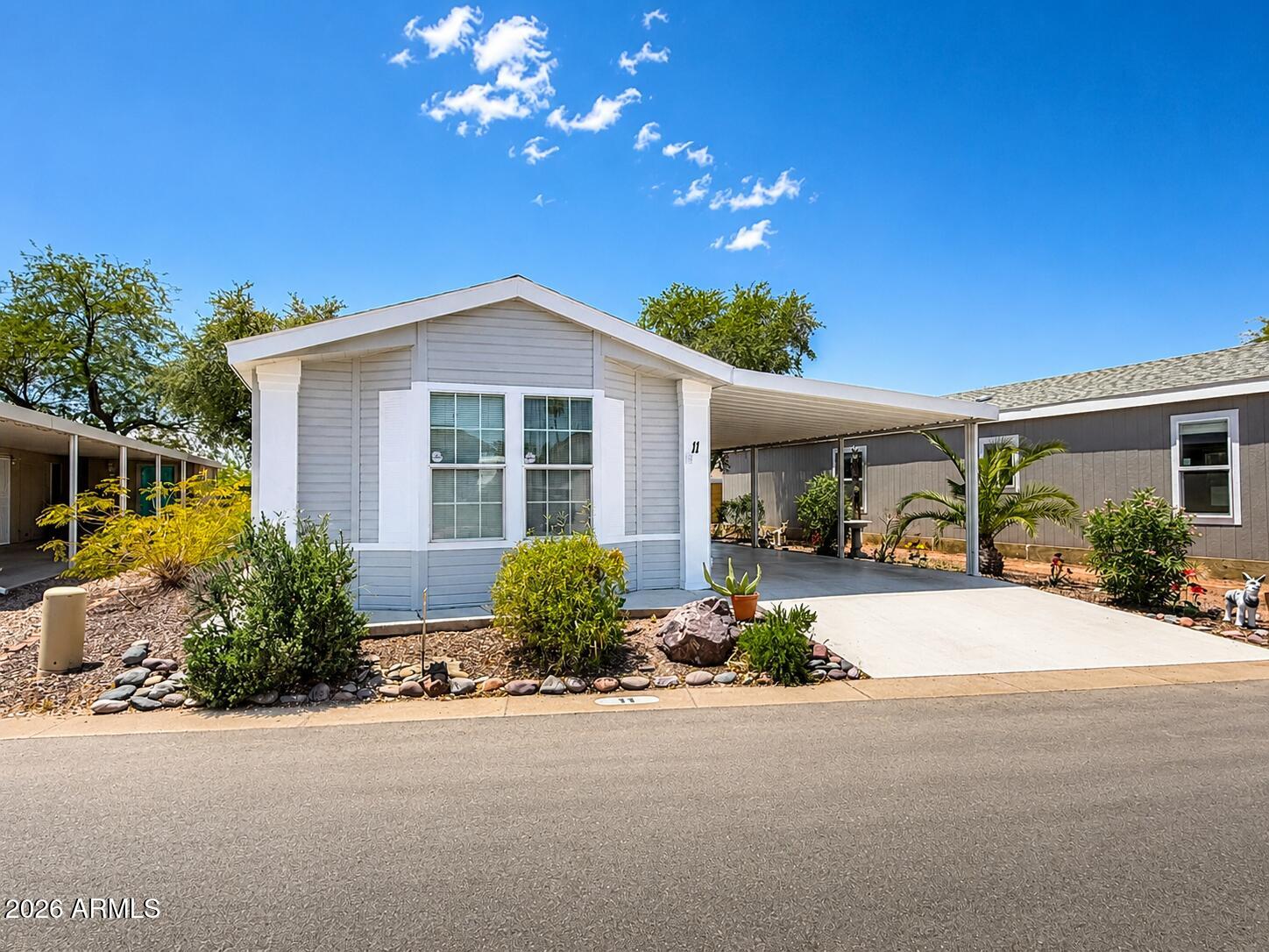 201 South Greenfield Road, Unit 11 Mesa, AZ 85206 - Photo 5 of 22 a front view of a house with a yard and outdoor seating