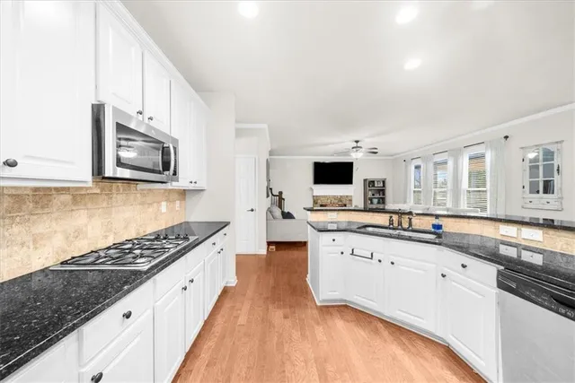 a dining room with wooden floor and a rug