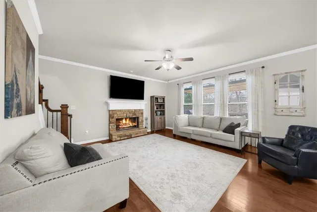 a living room with furniture a fireplace and a flat screen tv