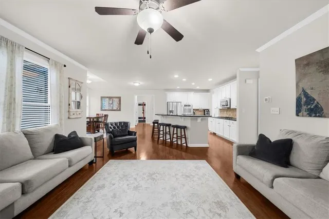 a bathroom with a sink a toilet a mirror and shower