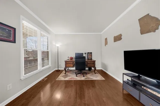 a spacious bedroom with a bed and a flat screen tv