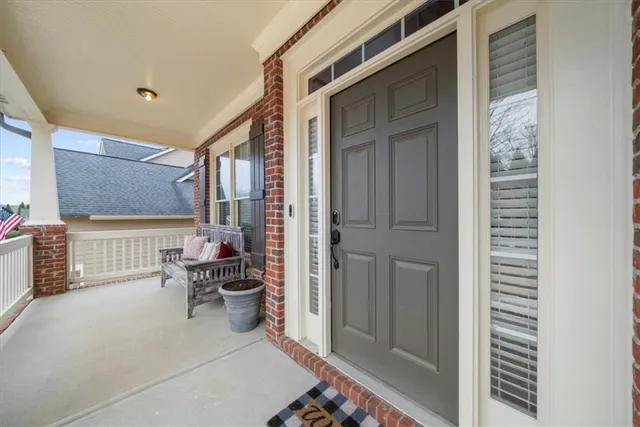 a hallway with a dining table and chairs with wooden floor