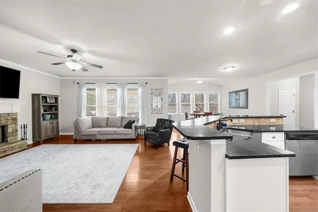 a large kitchen with stainless steel appliances granite countertop a stove a sink and a microwave