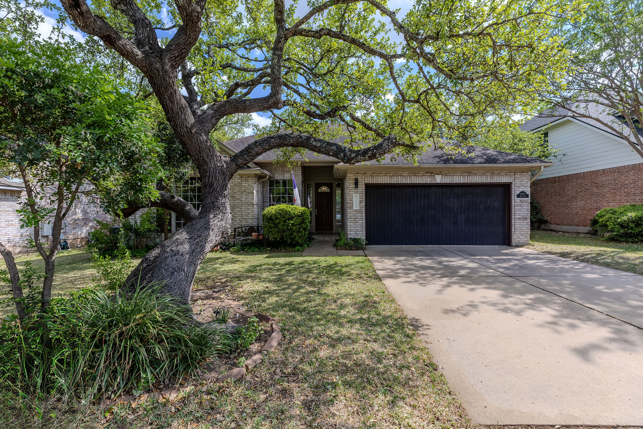 11113 Brista Way Austin, TX 78726 - Photo 1 of 1 a front view of a house with garden