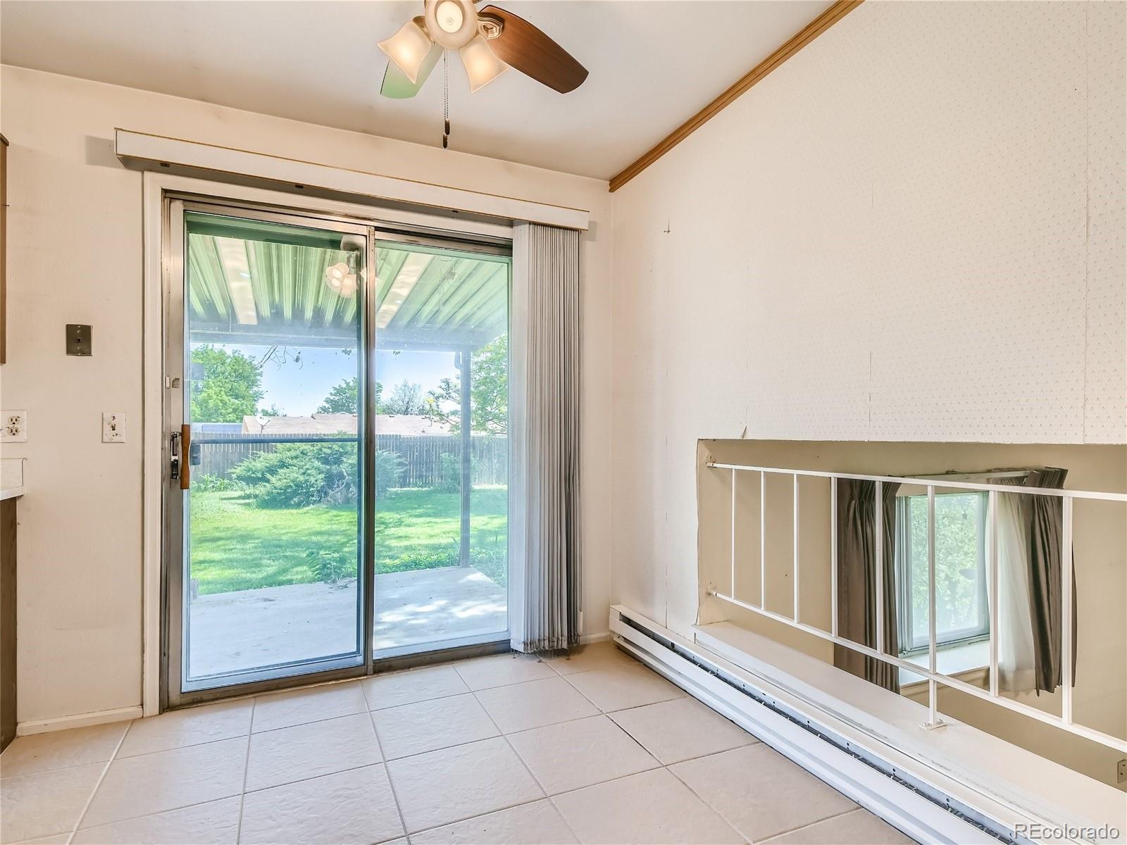 11090 Eudora Way Thornton, CO 80233 - Photo 11 of 28 a view of an empty room and window ceiling fan