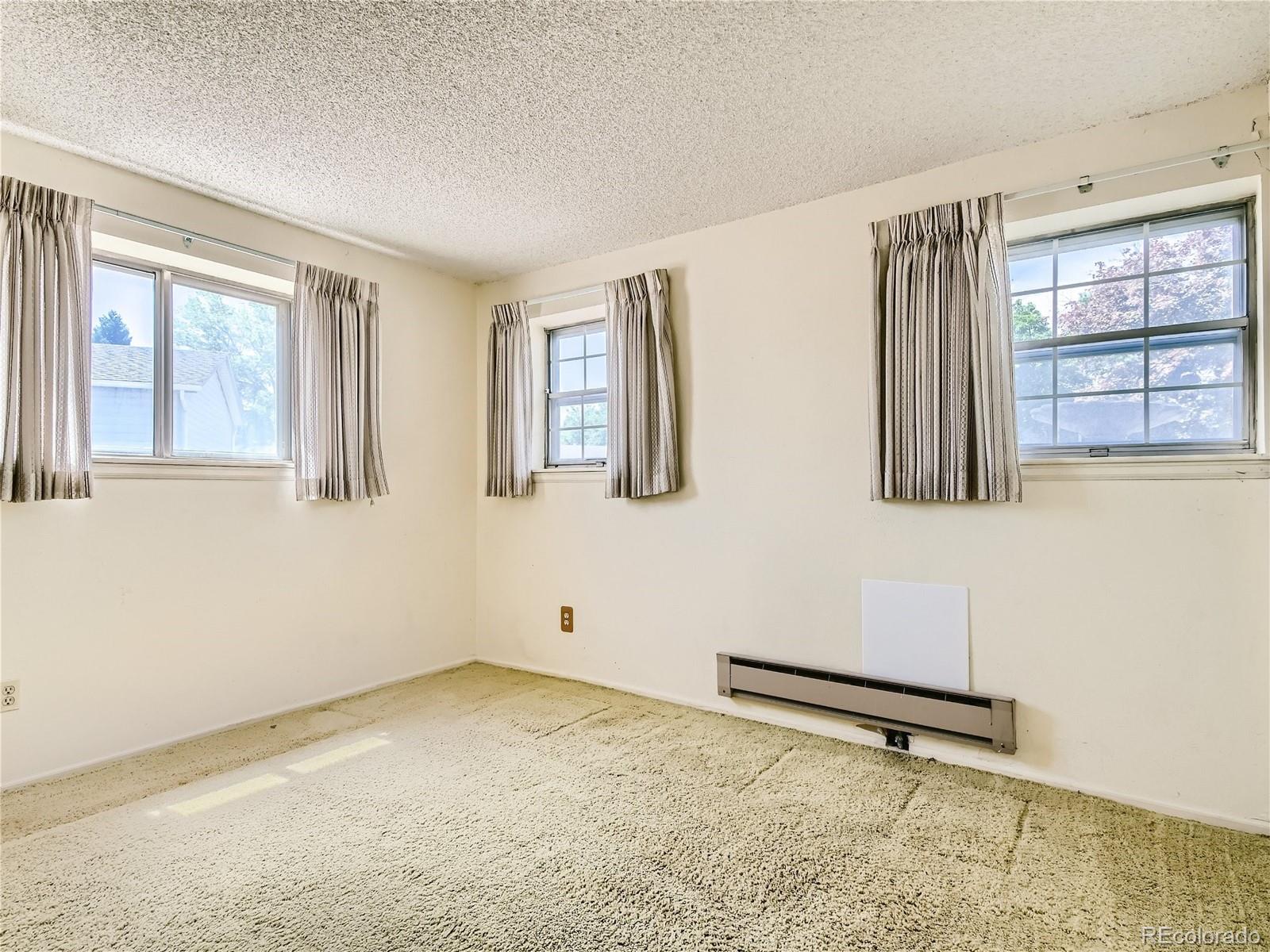 11090 Eudora Way Thornton, CO 80233 - Photo 14 of 28 a view of an empty room with a window