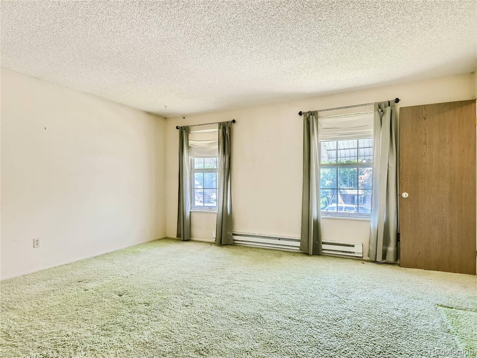 11090 Eudora Way Thornton, CO 80233 - Photo 17 of 28 an empty room with windows