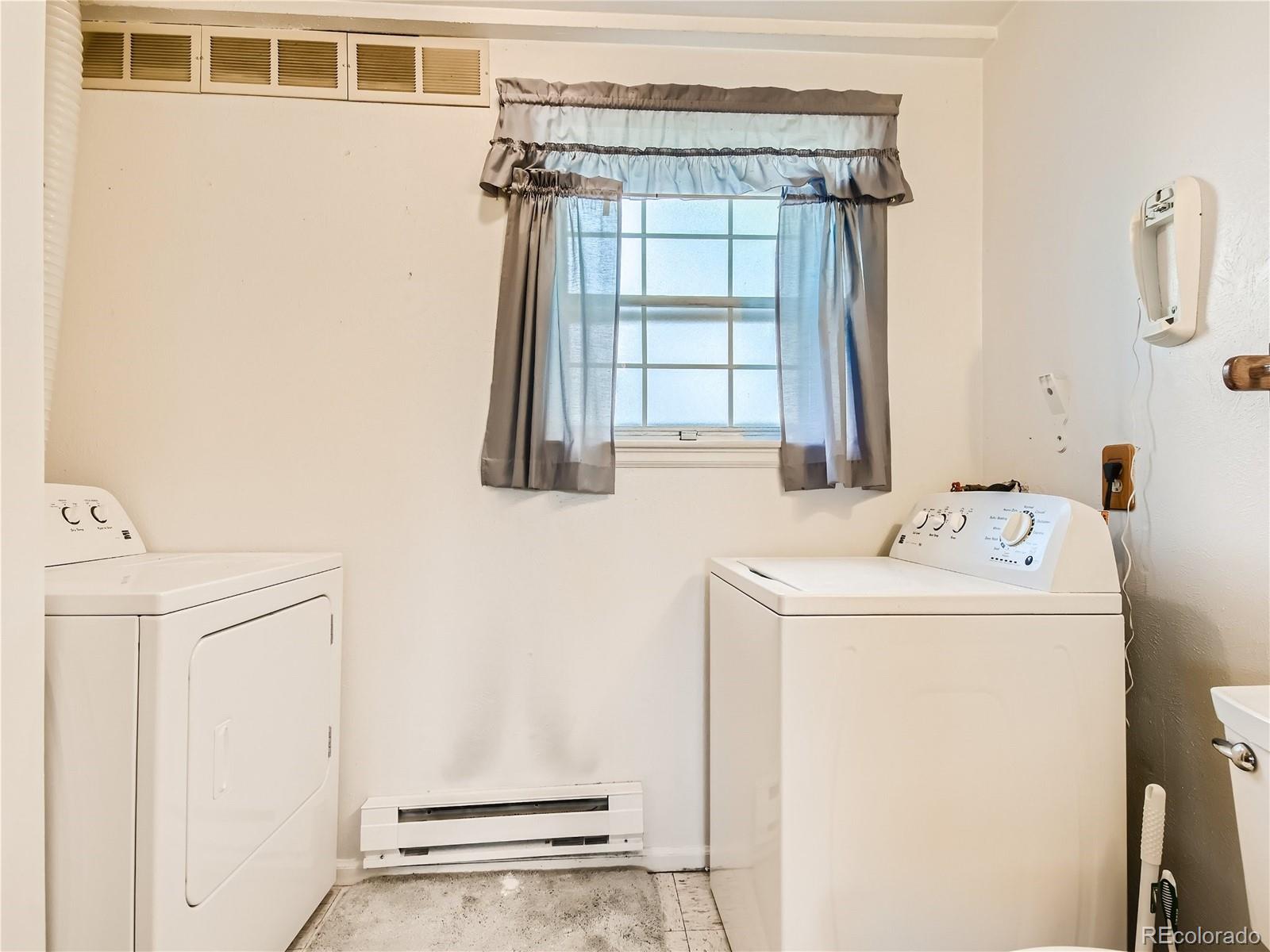 11090 Eudora Way Thornton, CO 80233 - Photo 24 of 28 a utility room with dryer and washer