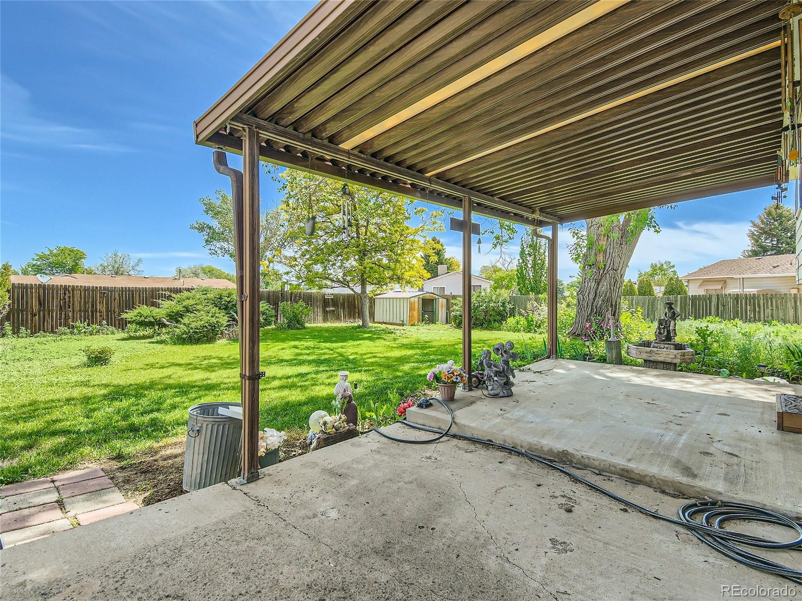 11090 Eudora Way Thornton, CO 80233 - Photo 26 of 28 a view of a house with backyard and a patio