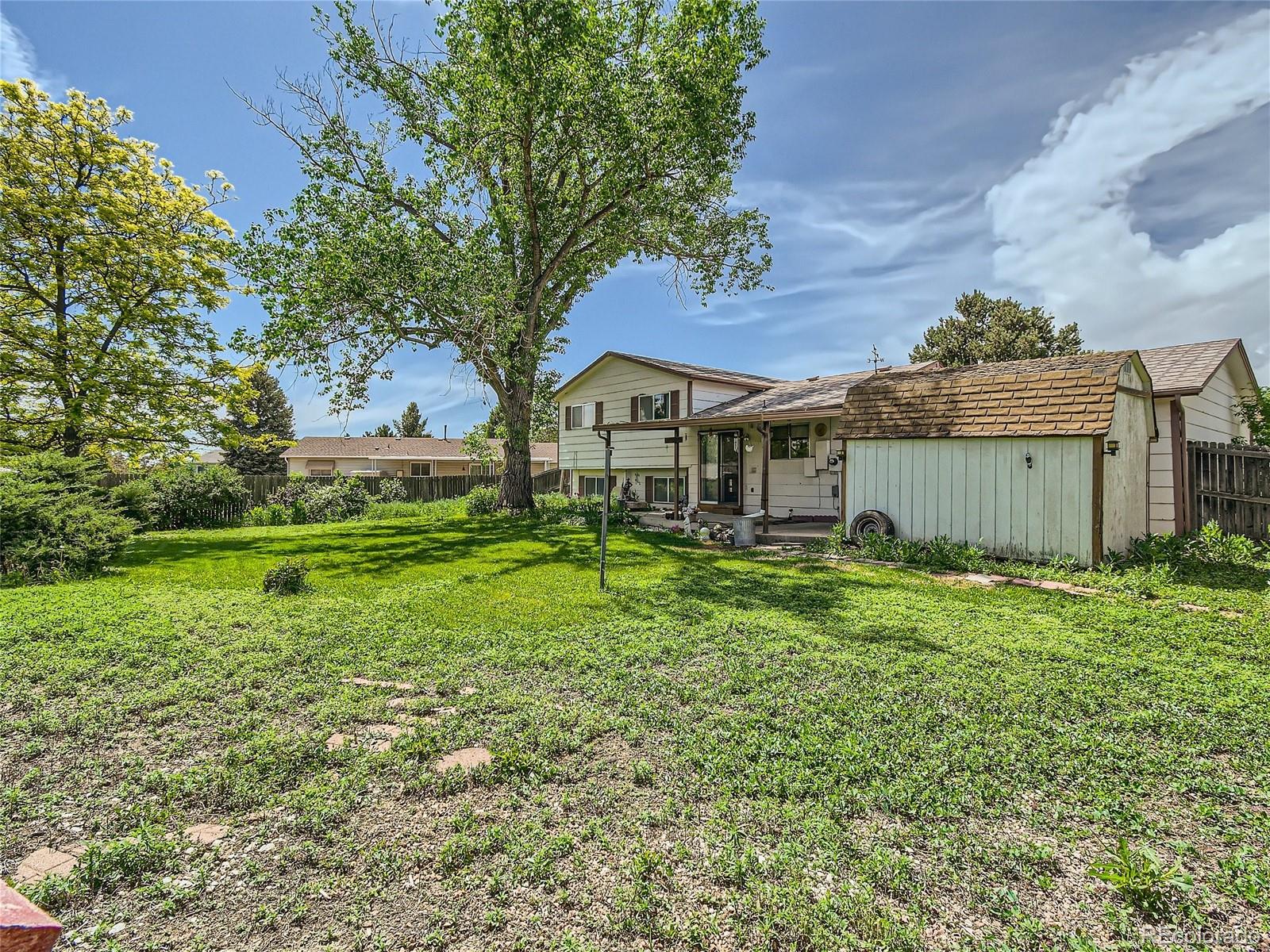 11090 Eudora Way Thornton, CO 80233 - Photo 27 of 28 a view of a house with a backyard