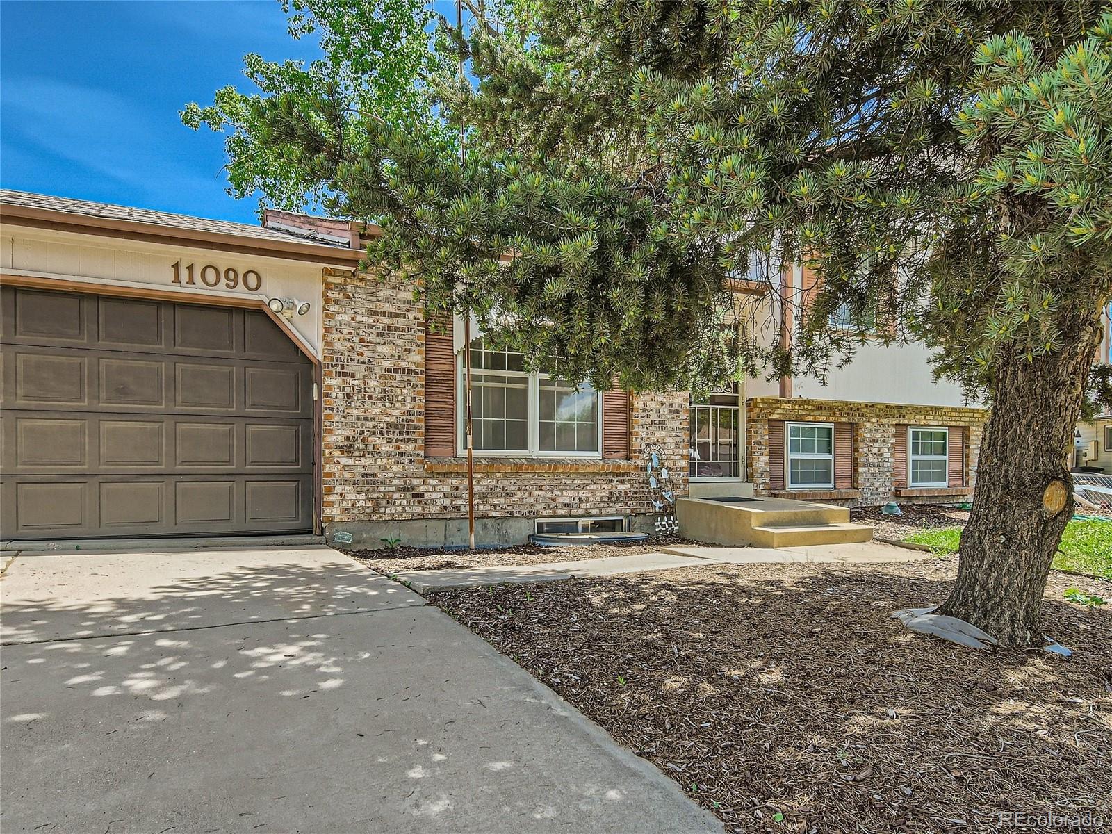 11090 Eudora Way Thornton, CO 80233 - Photo 3 of 28 a front view of a house with a yard