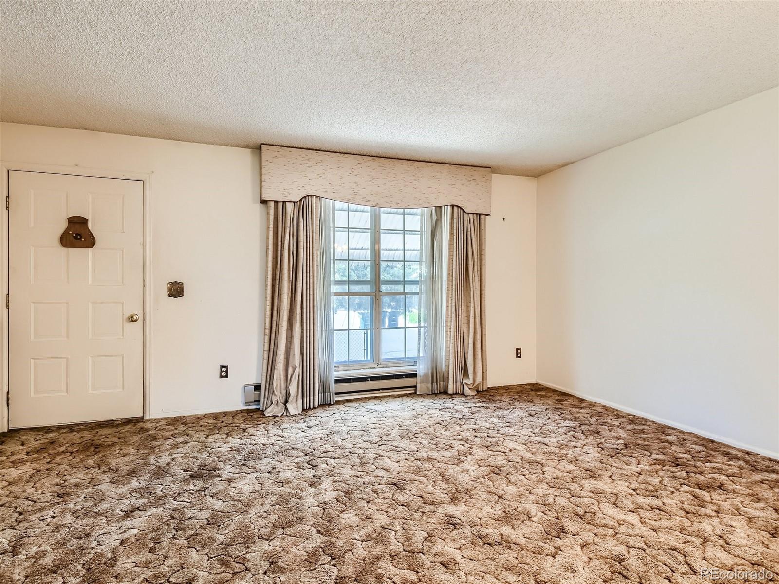 11090 Eudora Way Thornton, CO 80233 - Photo 5 of 28 a view of an empty room with a window