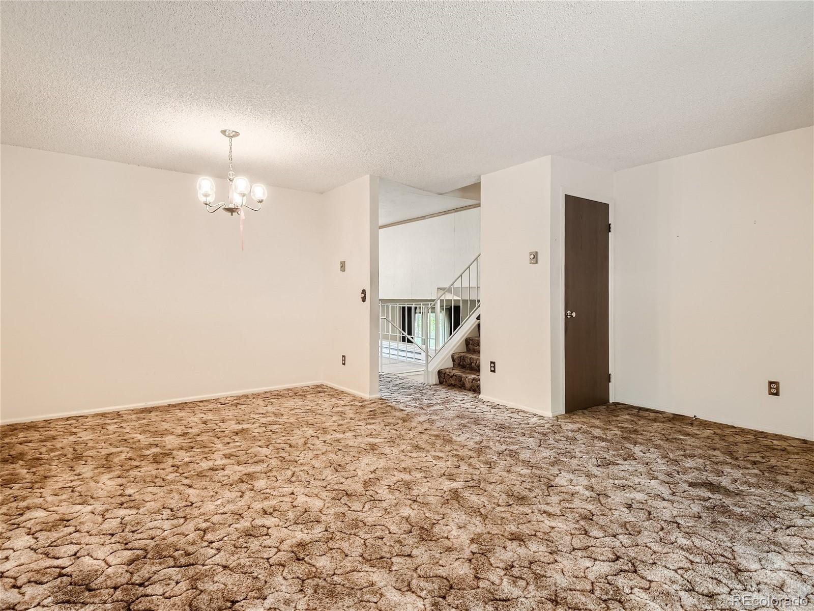 11090 Eudora Way Thornton, CO 80233 - Photo 6 of 28 a view of a livingroom with wooden floor