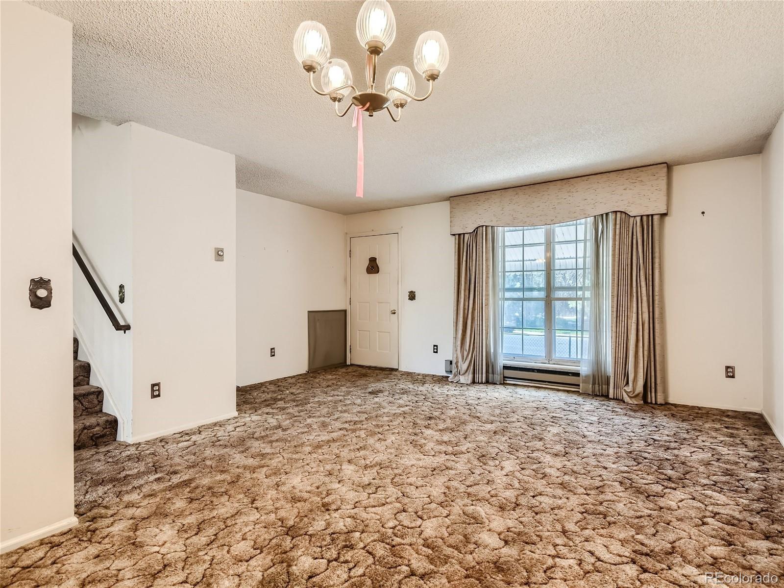 11090 Eudora Way Thornton, CO 80233 - Photo 7 of 28 a view of an empty room with a window