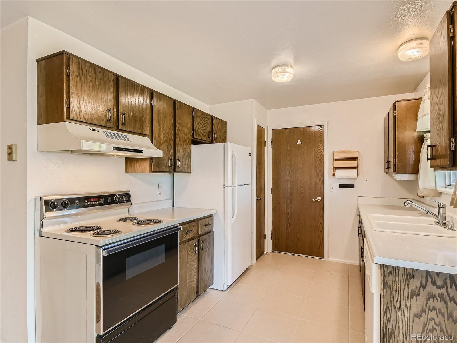 11090 Eudora Way Thornton, CO 80233 - Photo 8 of 28 a kitchen with stainless steel appliances a stove a refrigerator and a sink