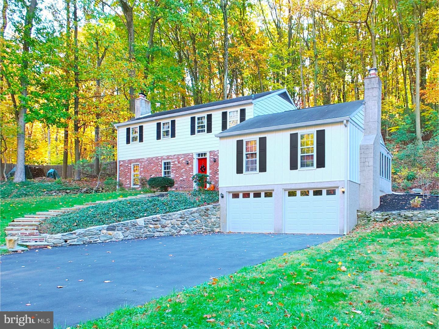 751 Mancill Road Wayne, PA 19087 - Photo 1 of 20 a front view of a house with a yard and garage
