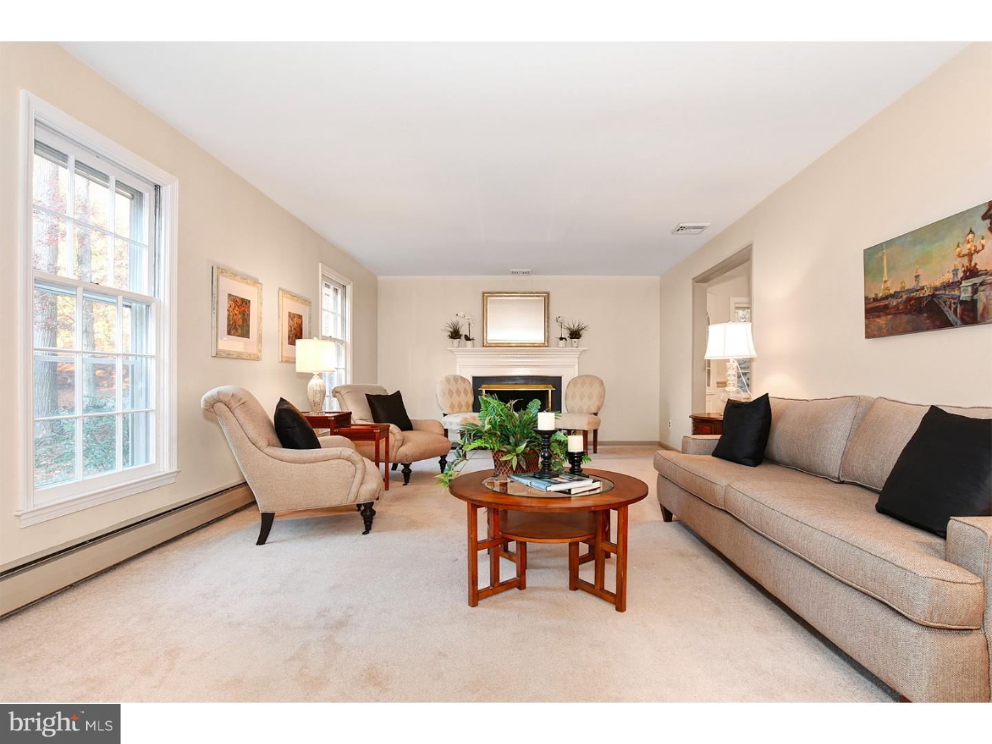 751 Mancill Road Wayne, PA 19087 - Photo 3 of 20 a living room with furniture a fireplace and a large window
